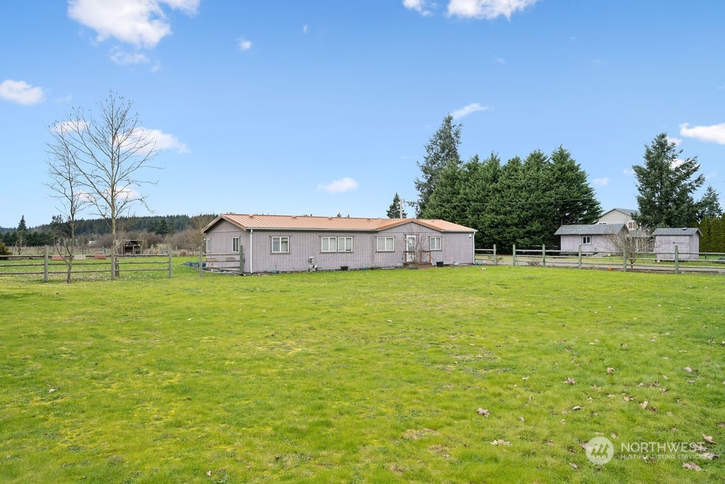 17043 Leitner Road Southwest Rochester, WA 98579 - Photo 4 of 18 a view of a house with a yard and a pool