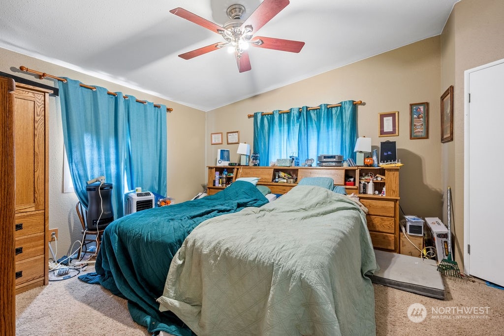 17043 Leitner Road Southwest Rochester, WA 98579 - Photo 10 of 18 a bed room with a bed and a chandelier