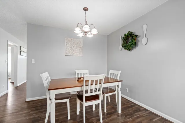 a view of a dining room with furniture wooden floor and chandelier