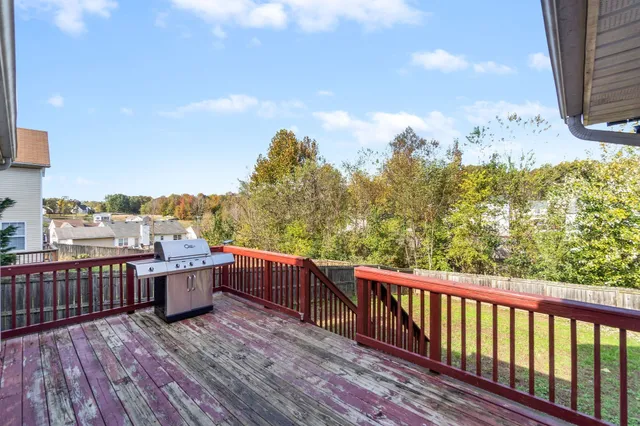 a view of roof deck with wooden floor and fence
