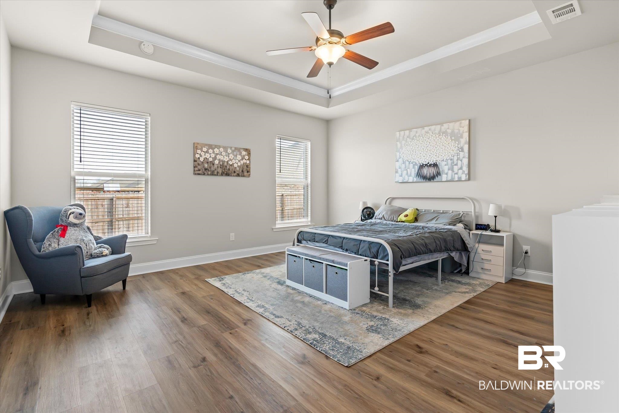 1116 Stella Road Foley, AL 36535 - Photo 12 of 29 Bedroom featuring ceiling fan, a tray ceiling, and multiple windows
