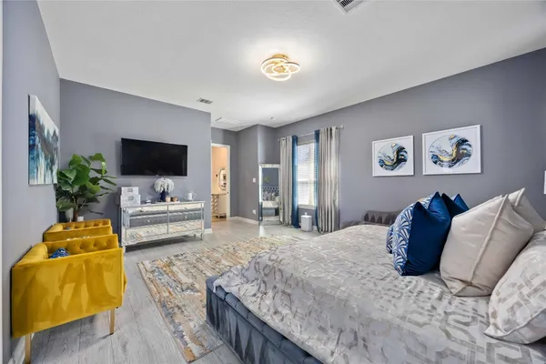 a bedroom with a bed and couch