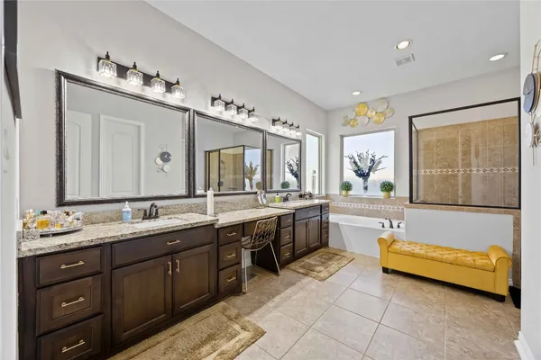 a bathroom with a tub sink and mirror