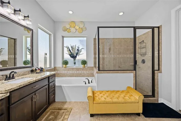 a bathroom with a double vanity sink and a bathtub