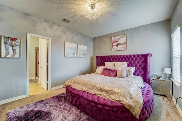 a bedroom with a bed and a chandelier
