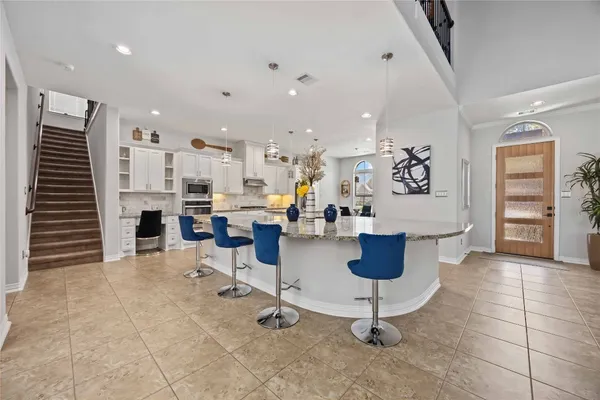 a living room with furniture and kitchen view