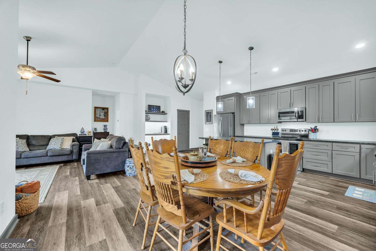153 North Point Circle Hartwell, GA 30643 - Photo 17 of 60 a view of a dining room with furniture a kitchen and chandelier