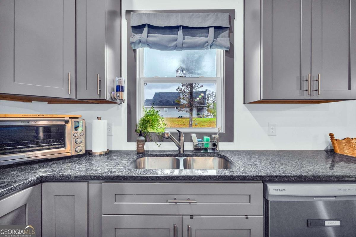 153 North Point Circle Hartwell, GA 30643 - Photo 21 of 60 a kitchen with granite countertop a sink and a stove