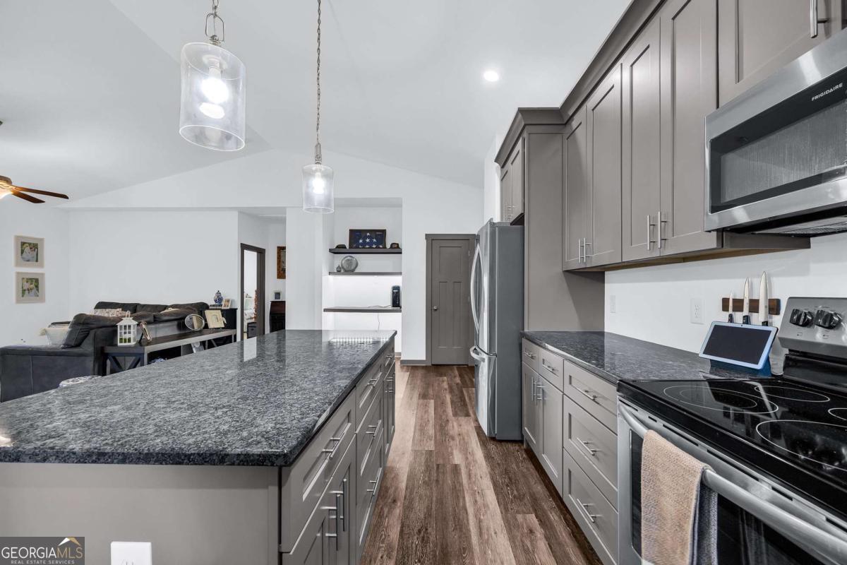 153 North Point Circle Hartwell, GA 30643 - Photo 23 of 60 a kitchen with stainless steel appliances granite countertop a sink a stove and a refrigerator