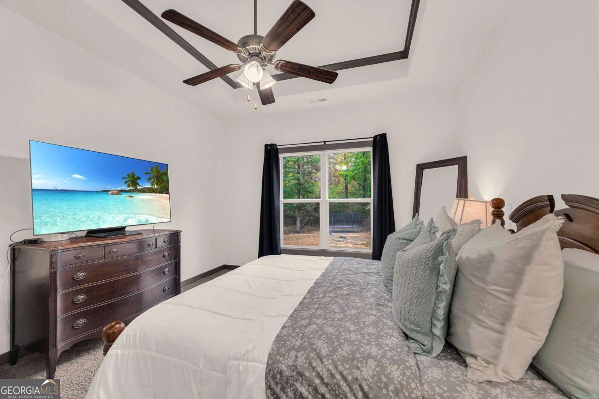 153 North Point Circle Hartwell, GA 30643 - Photo 30 of 60 a bedroom with a bed and a flat tv screen on dresser