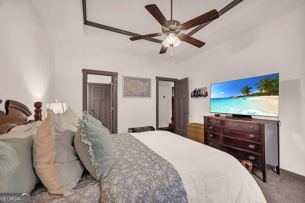 153 North Point Circle Hartwell, GA 30643 - Photo 32 of 60 a bedroom with a bed and a chandelier