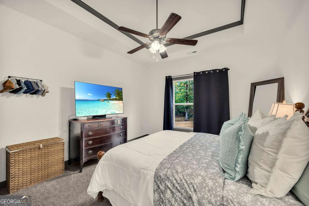 153 North Point Circle Hartwell, GA 30643 - Photo 33 of 60 a bedroom with a bed and a flat screen tv