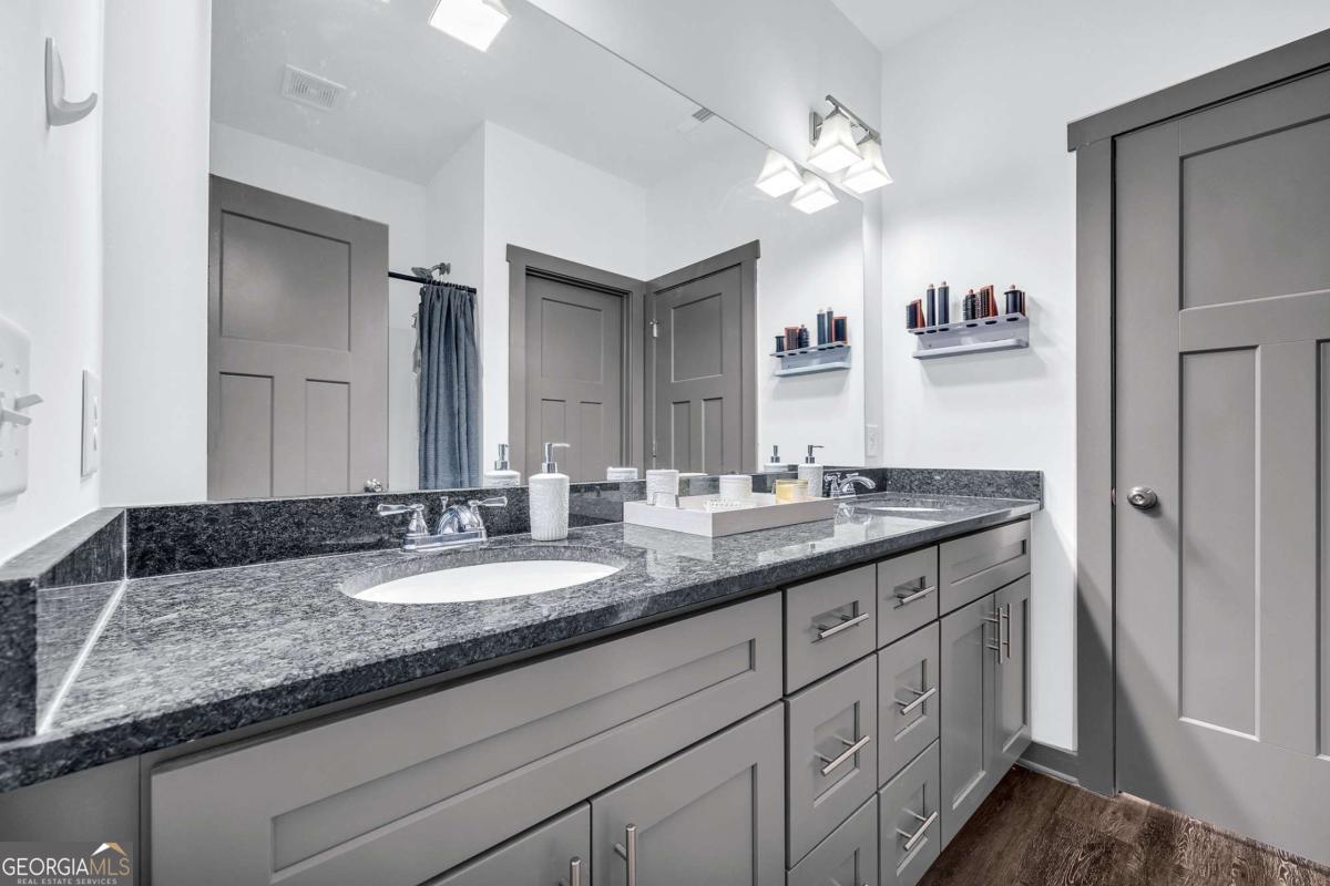 153 North Point Circle Hartwell, GA 30643 - Photo 35 of 60 a bathroom with a granite countertop double vanity sink and a mirror