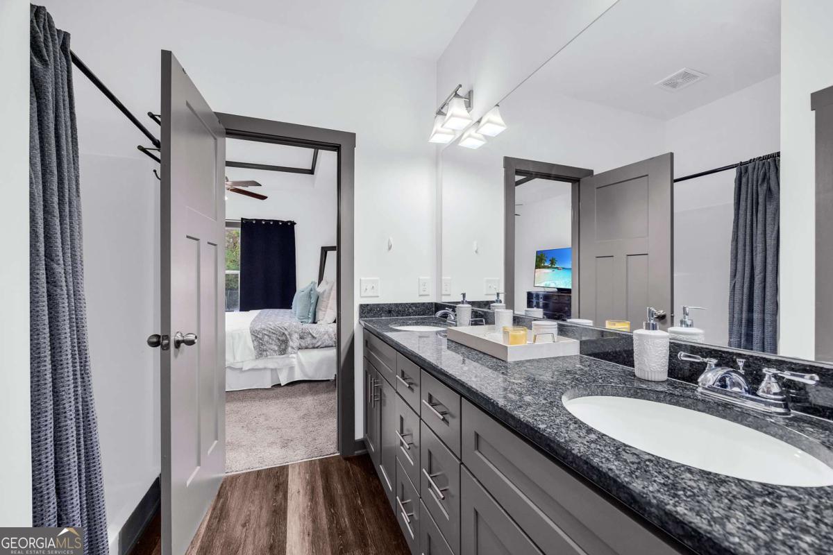 153 North Point Circle Hartwell, GA 30643 - Photo 37 of 60 a en suite bathroom with a double vanity sink a mirror and shower