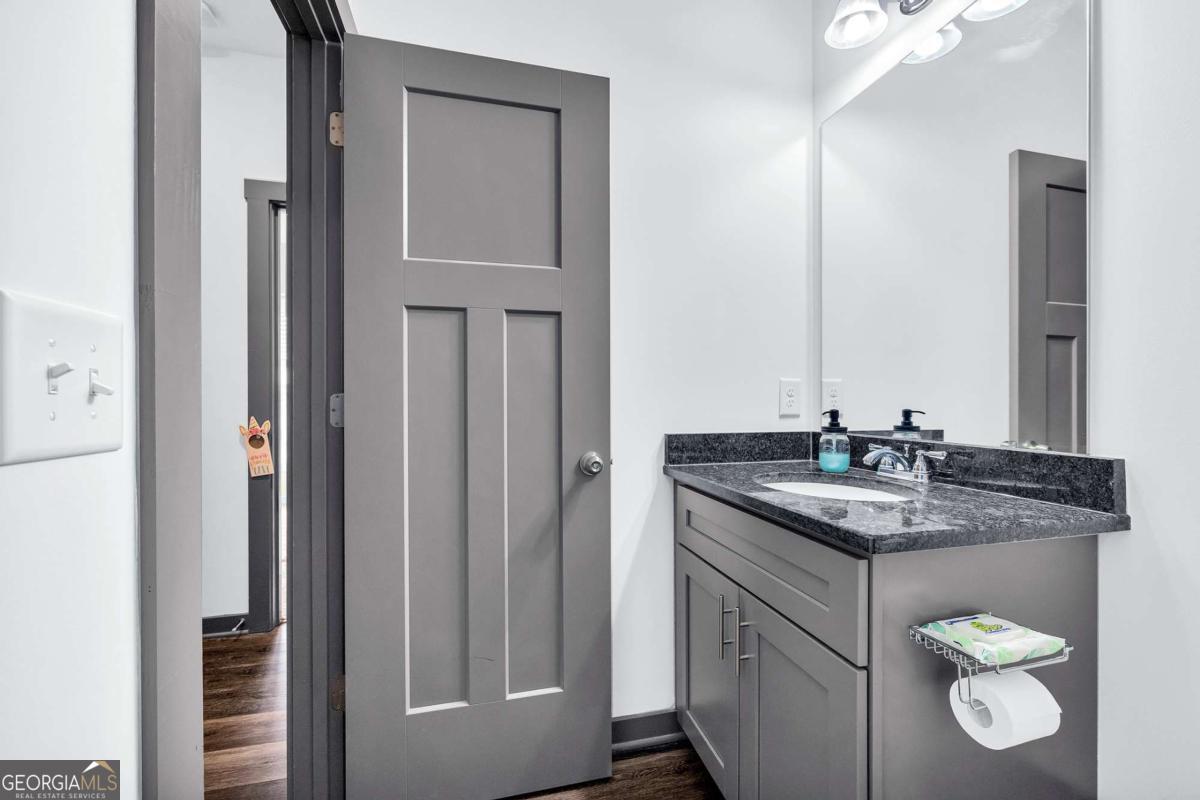 153 North Point Circle Hartwell, GA 30643 - Photo 46 of 60 a bathroom with a granite countertop sink and a mirror
