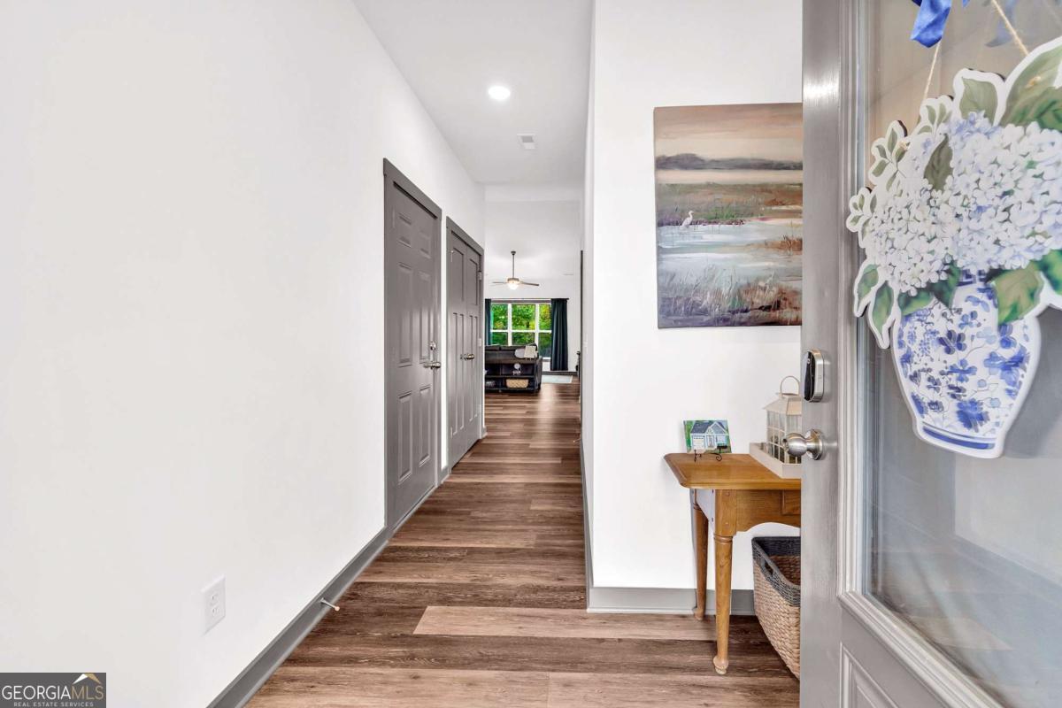 153 North Point Circle Hartwell, GA 30643 - Photo 6 of 60 a hallway with furniture and a chandelier