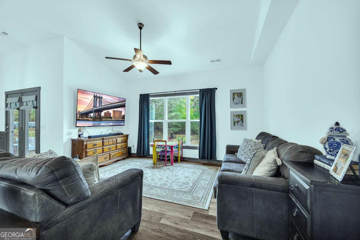 153 North Point Circle Hartwell, GA 30643 - Photo 10 of 60 a living room with furniture ceiling fan and a window