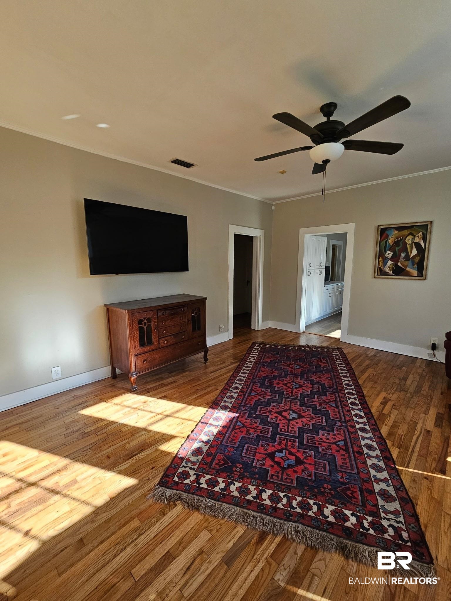 1215 Church Street Mobile, AL 36604 - Photo 2 of 23 Living area with light wood-style flooring, visible vents, baseboards, and ornamental molding
