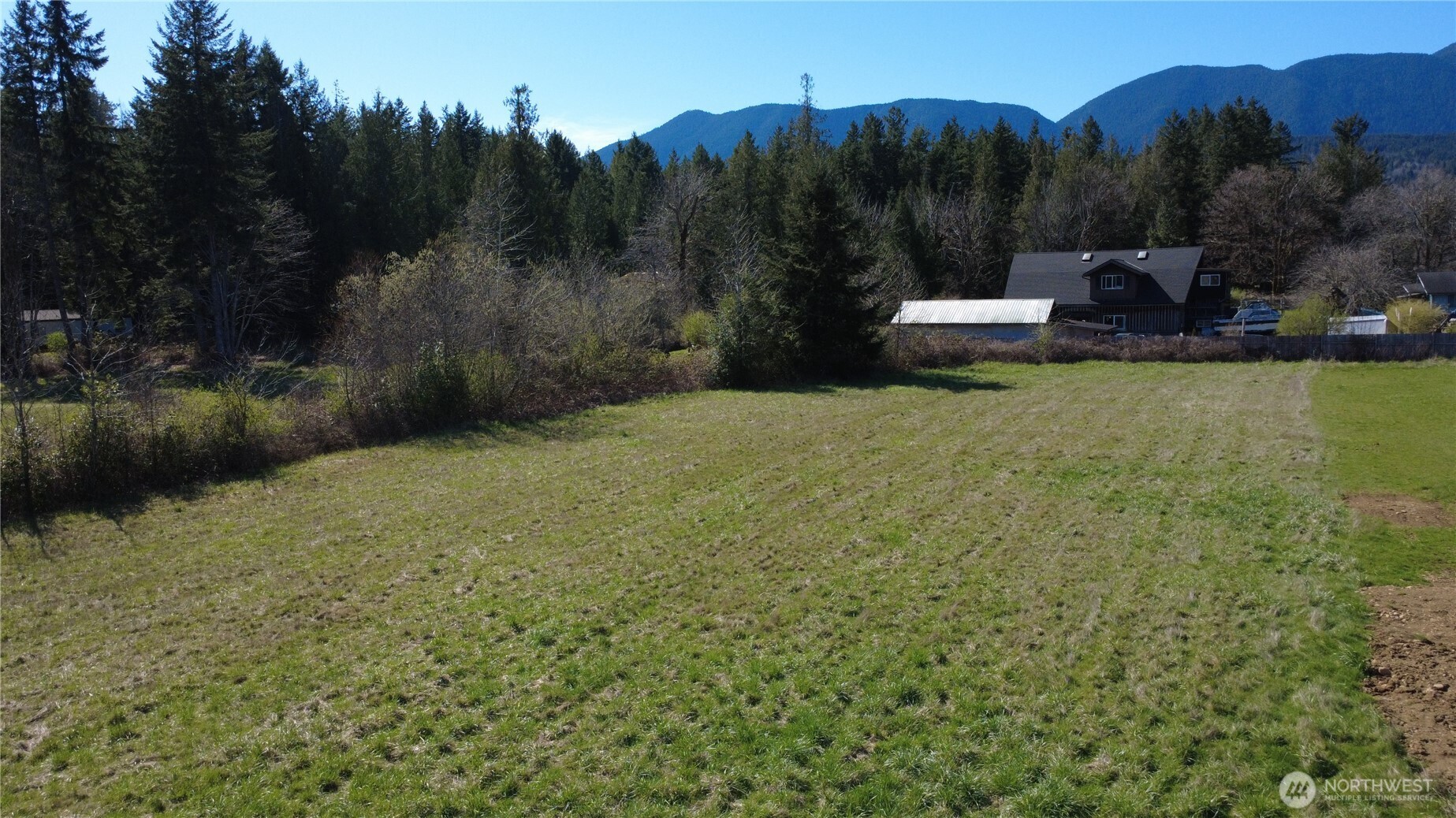 29438 Highway 101 Quilcene, WA 98376 - Photo 1 of 8 a view of a garden with an outdoor seating