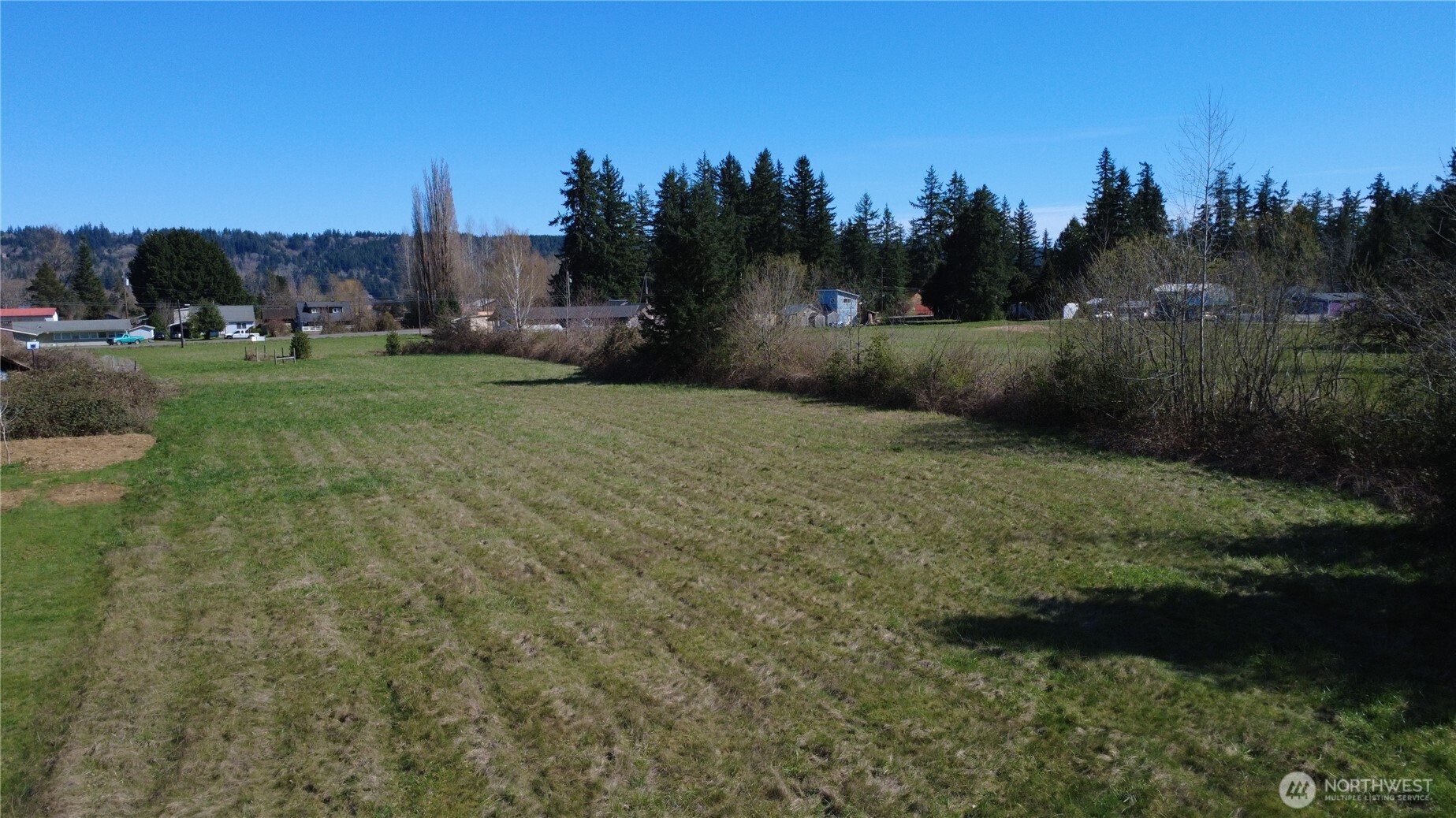 29438 Highway 101 Quilcene, WA 98376 - Photo 4 of 8 a view of a field of grass and trees