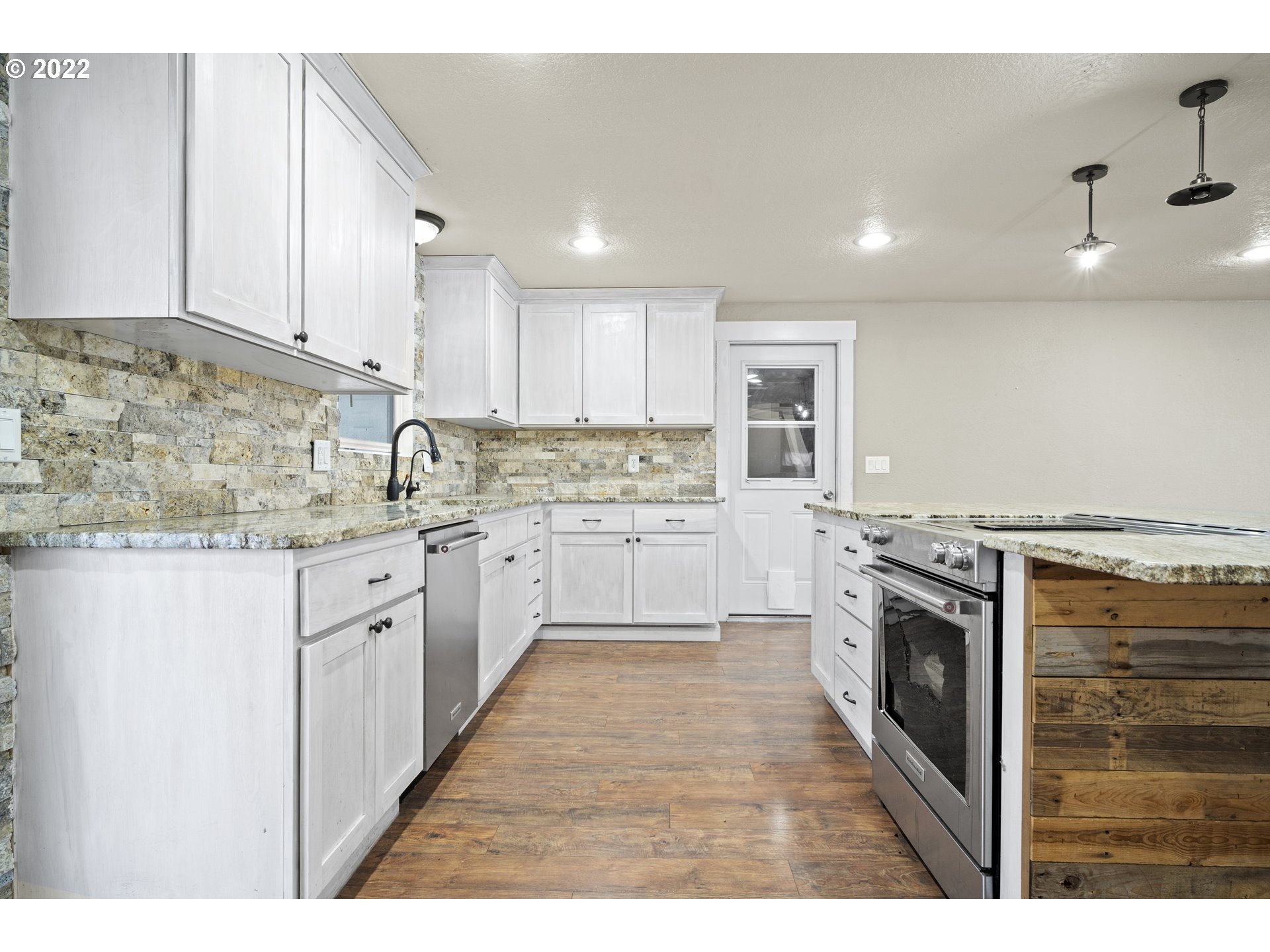13644 Agate Road Eagle Point, OR 97524 - Photo 5 of 32 a kitchen with stainless steel appliances granite countertop a stove a sink and a refrigerator
