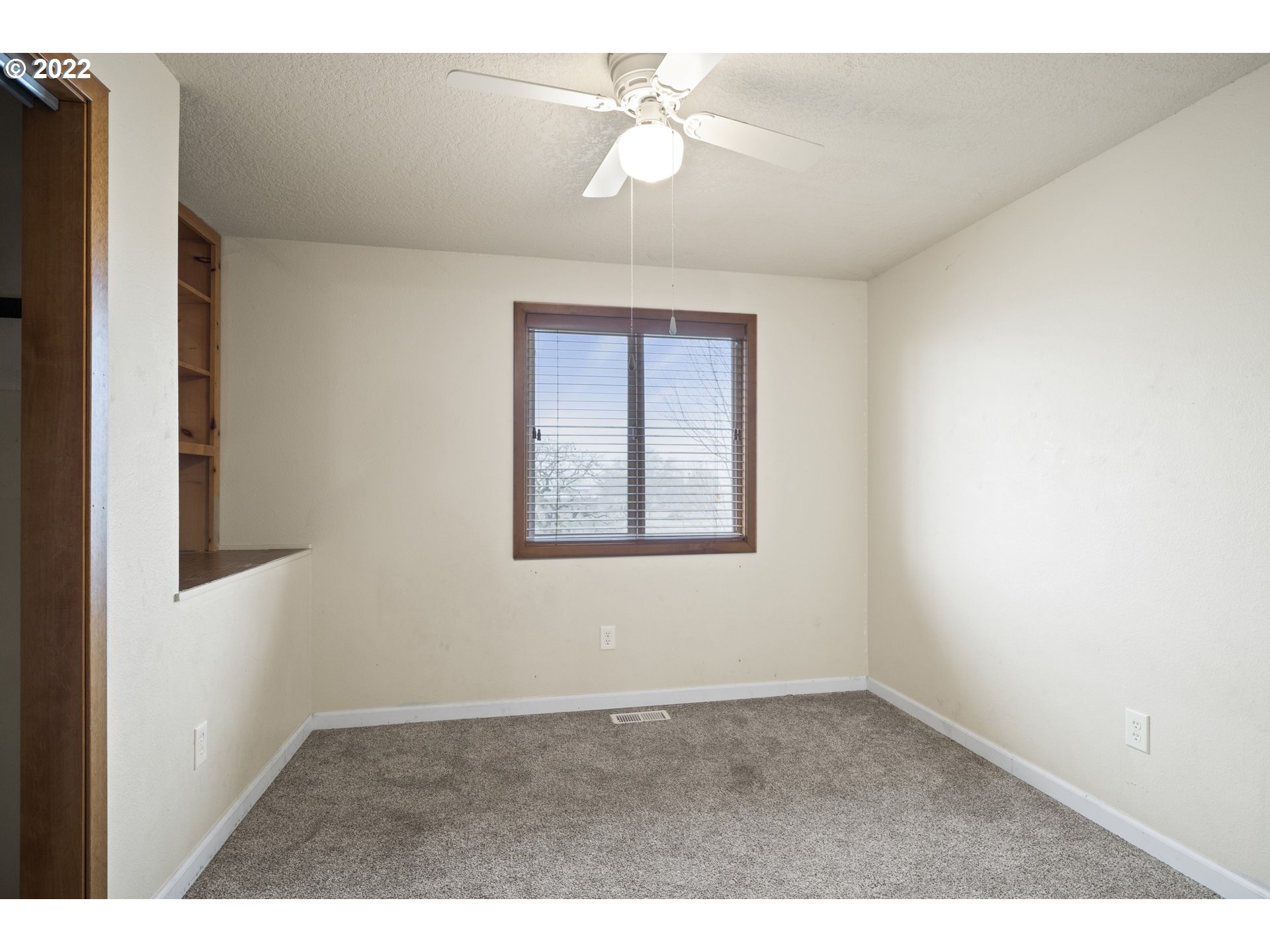 13644 Agate Road Eagle Point, OR 97524 - Photo 9 of 32 a view of an empty room with a window