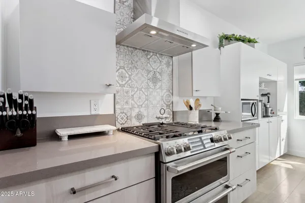 a kitchen with cabinets a sink and a stove