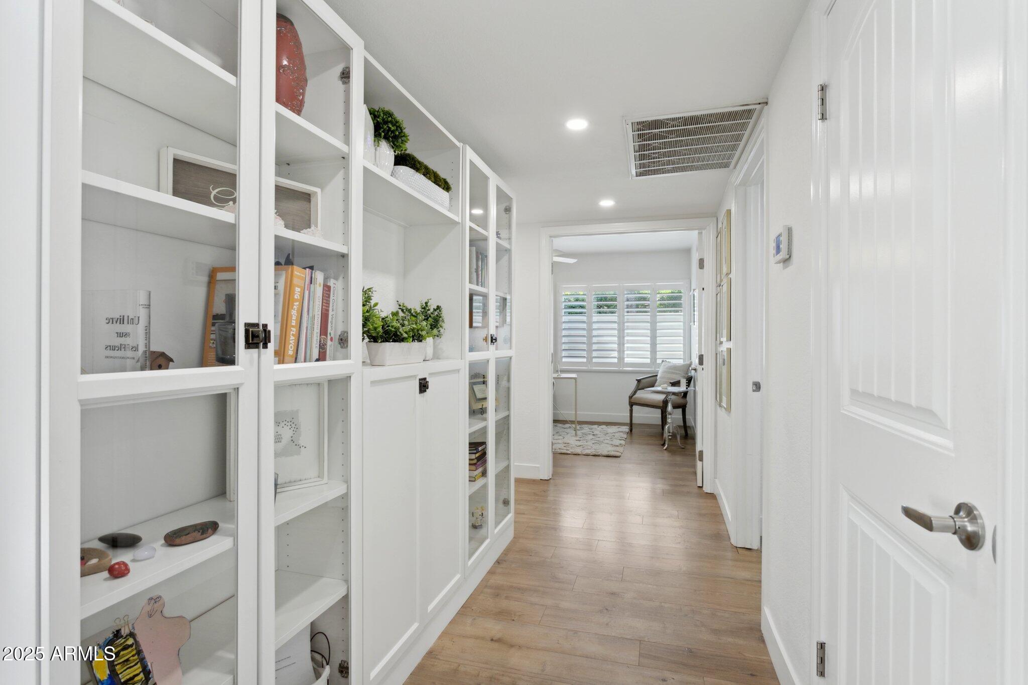 216 West Winged Foot Road Phoenix, AZ 85023 - Photo 12 of 55 a view of a hallway with wooden floor and staircase