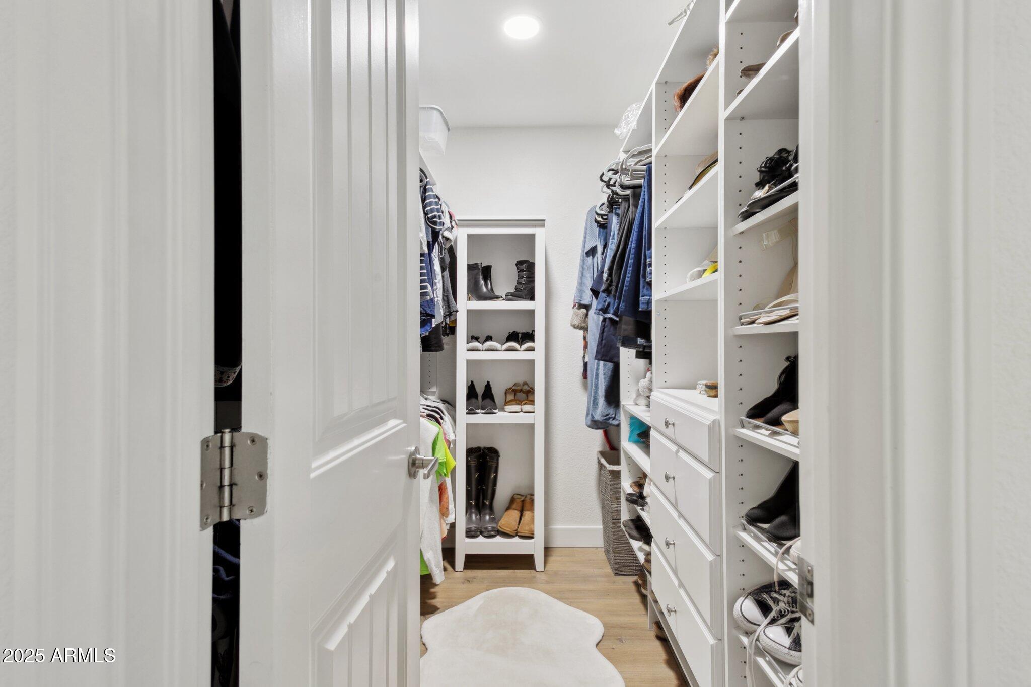 216 West Winged Foot Road Phoenix, AZ 85023 - Photo 19 of 55 a view of walk in closet with clothes and shoes