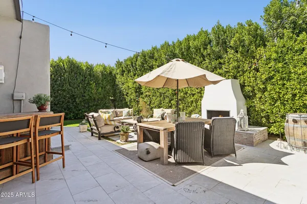 a view of a patio with couple of chairs and a fire pit