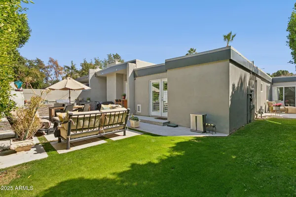 a view of backyard of house with seating space