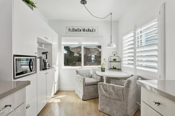a kitchen with kitchen island white cabinets stove and sink