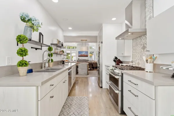 a living room with furniture a large window and a flat screen tv