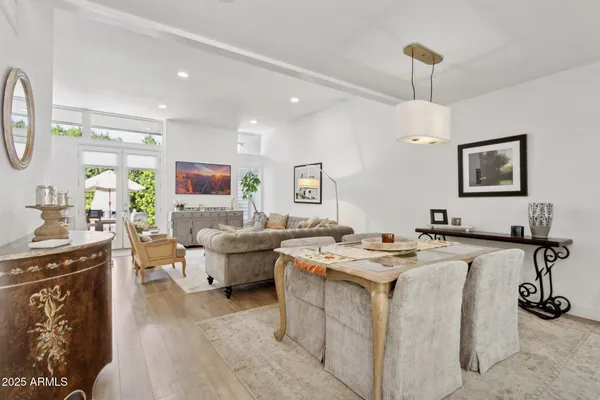 a living room with furniture and a view of kitchen