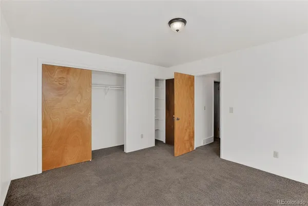 a bedroom with furniture and a flat screen tv
