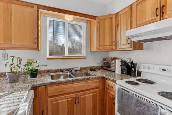 a kitchen with sink cabinets and window
