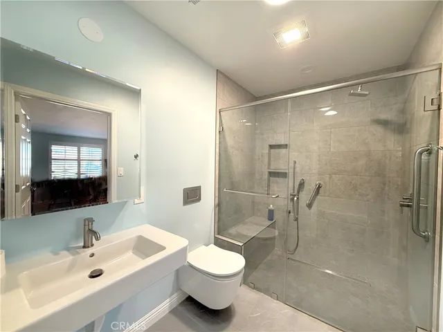 a bathroom with a sink toilet and shower