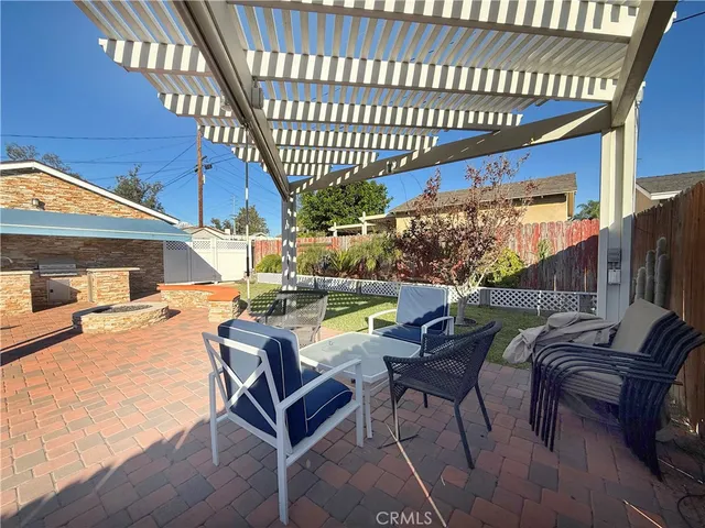 a view of a patio with a table and chairs
