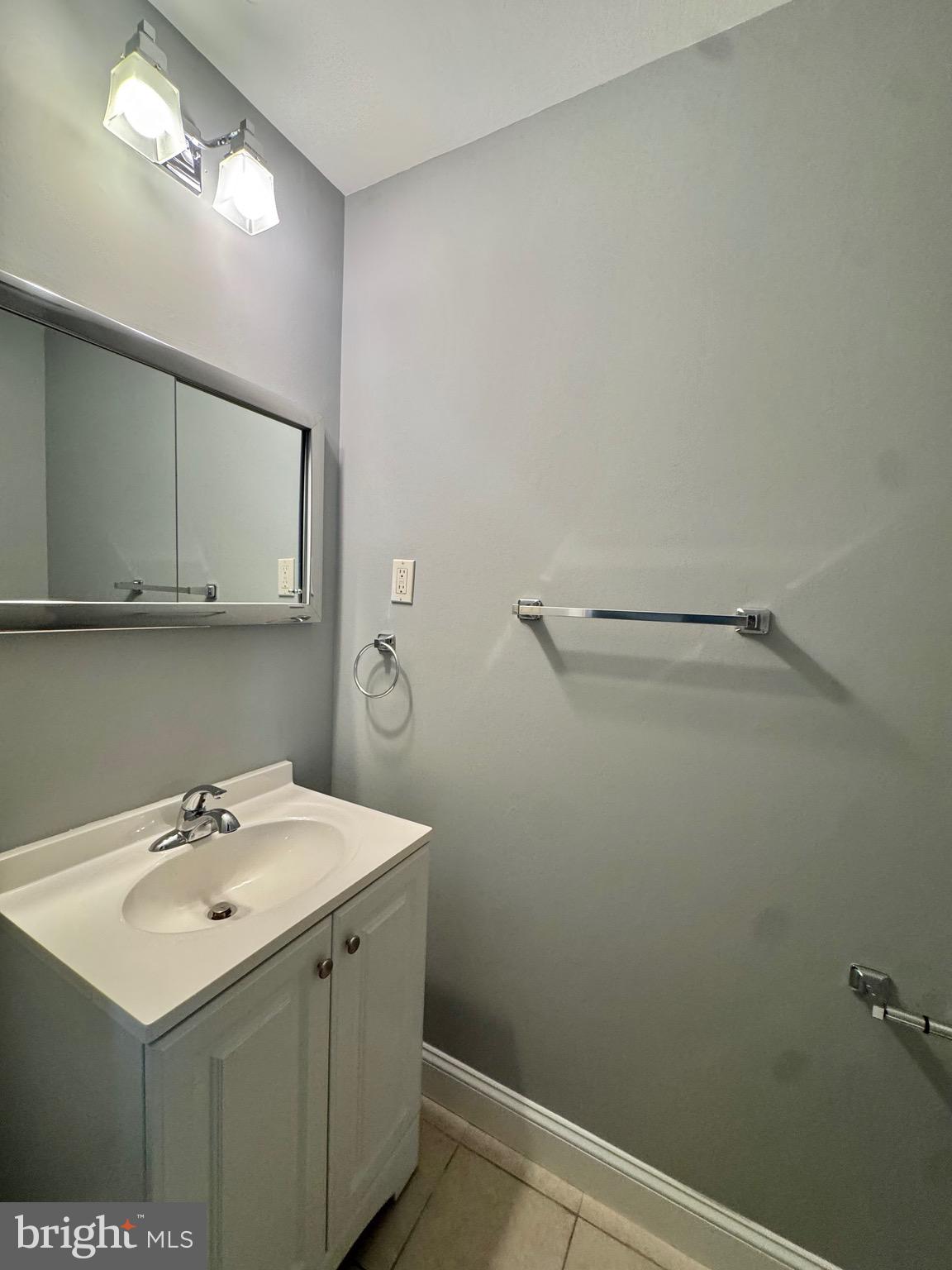 4908 Rocky Spring Lane Bowie, MD 20715 - Photo 6 of 36 a bathroom with a sink and mirror