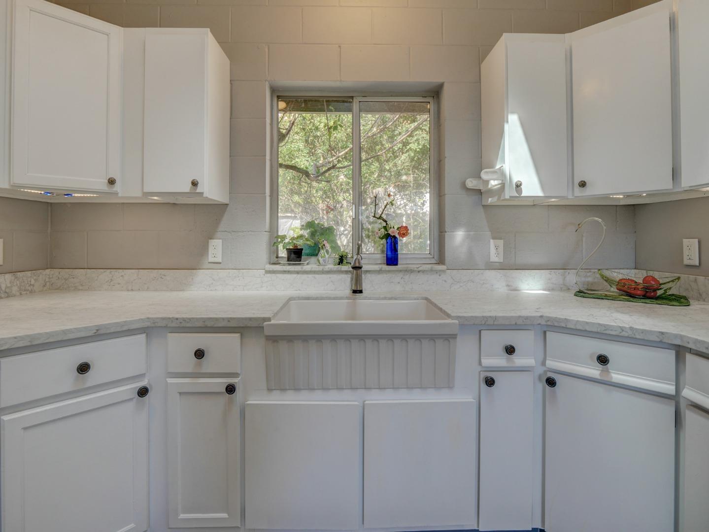 770 Calabasas Road Watsonville, CA 95076 - Photo 7 of 39 a kitchen with white cabinets and a window