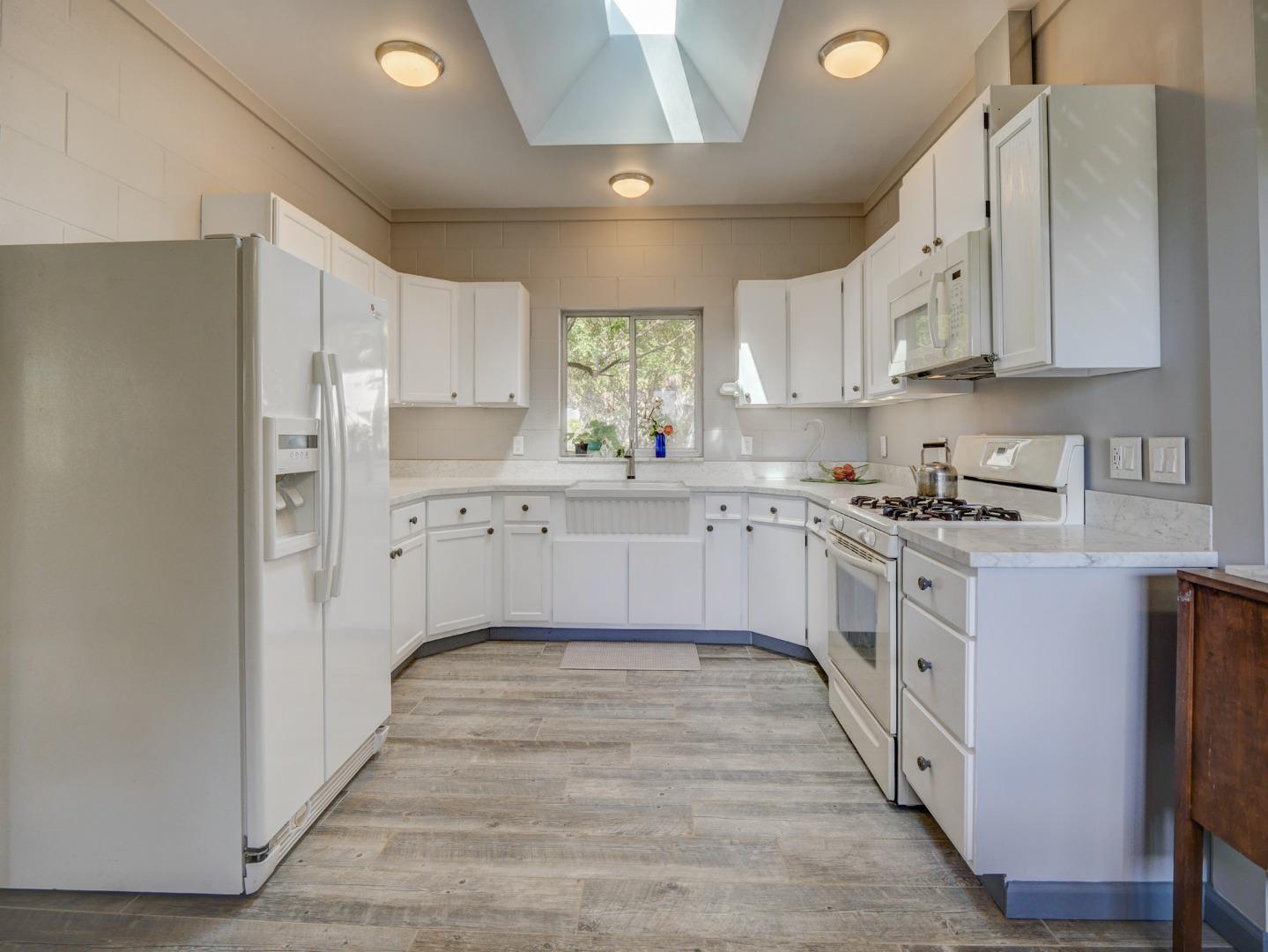 770 Calabasas Road Watsonville, CA 95076 - Photo 8 of 39 a kitchen with white cabinets appliances and sink
