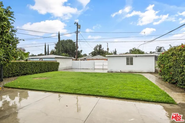 a view of a backyard with plants and a garden