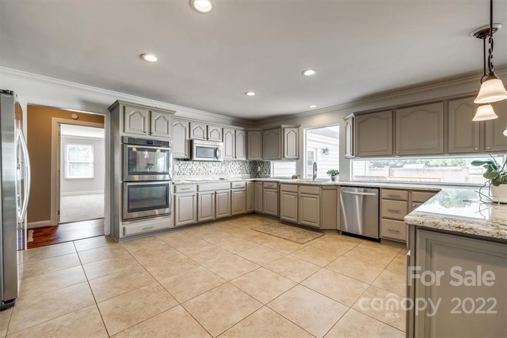 5249 Willow Pond Road Lake Wylie, SC 29710 - Photo 21 of 45 a kitchen with granite countertop a sink stainless steel appliances and cabinets