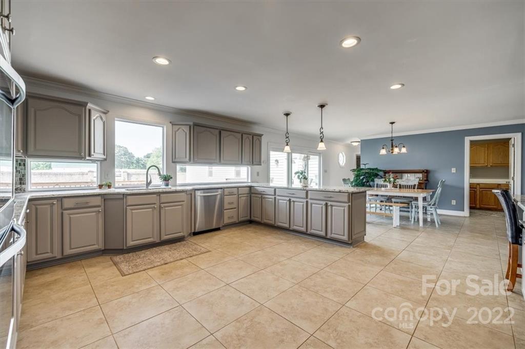 5249 Willow Pond Road Lake Wylie, SC 29710 - Photo 22 of 45 a kitchen with a sink white cabinets and glass table chairs