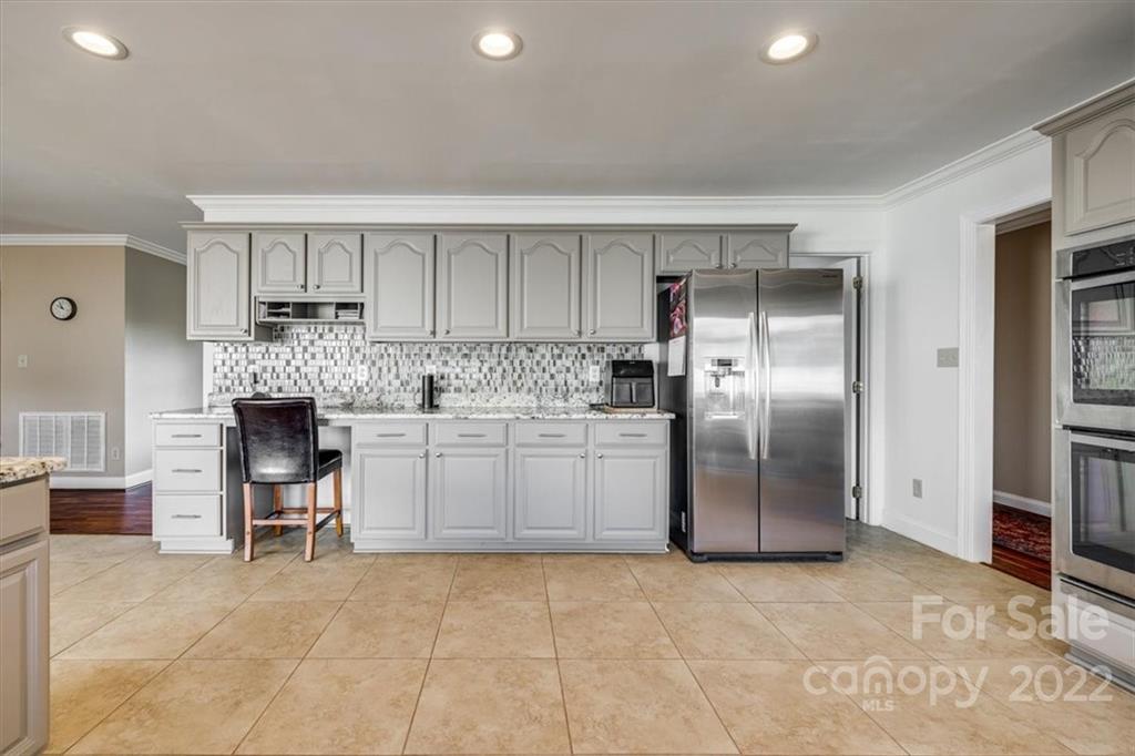 5249 Willow Pond Road Lake Wylie, SC 29710 - Photo 23 of 45 a kitchen with granite countertop a refrigerator and a stove top oven