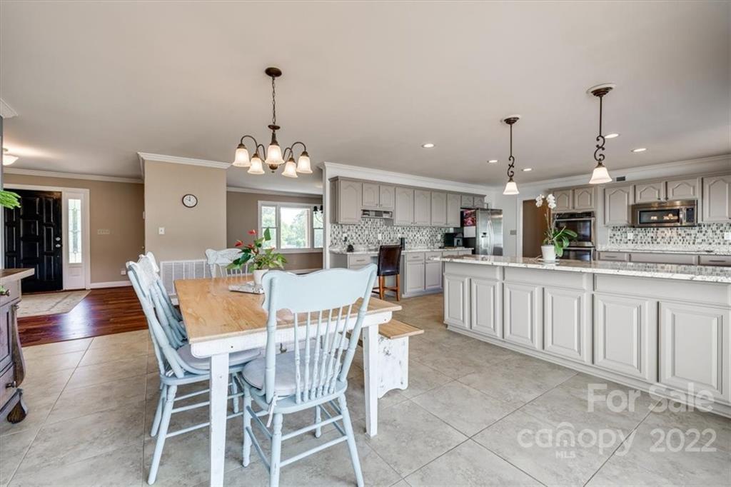 5249 Willow Pond Road Lake Wylie, SC 29710 - Photo 26 of 45 a view of a dining room and livingroom with furniture wooden floor a chandelier