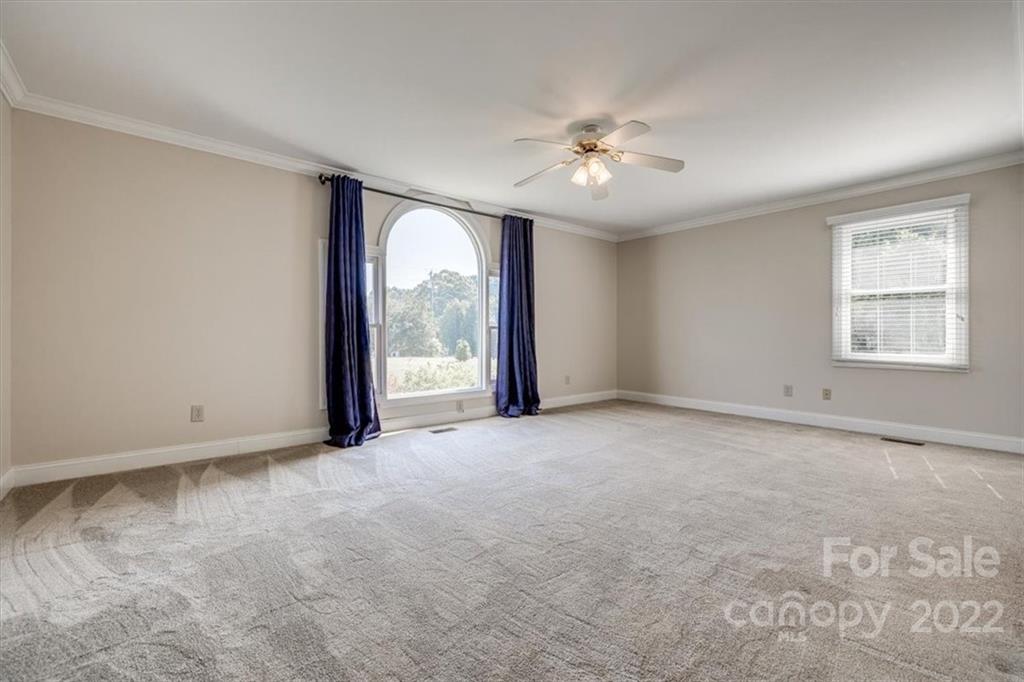 5249 Willow Pond Road Lake Wylie, SC 29710 - Photo 35 of 45 an empty room with chandelier fan and windows