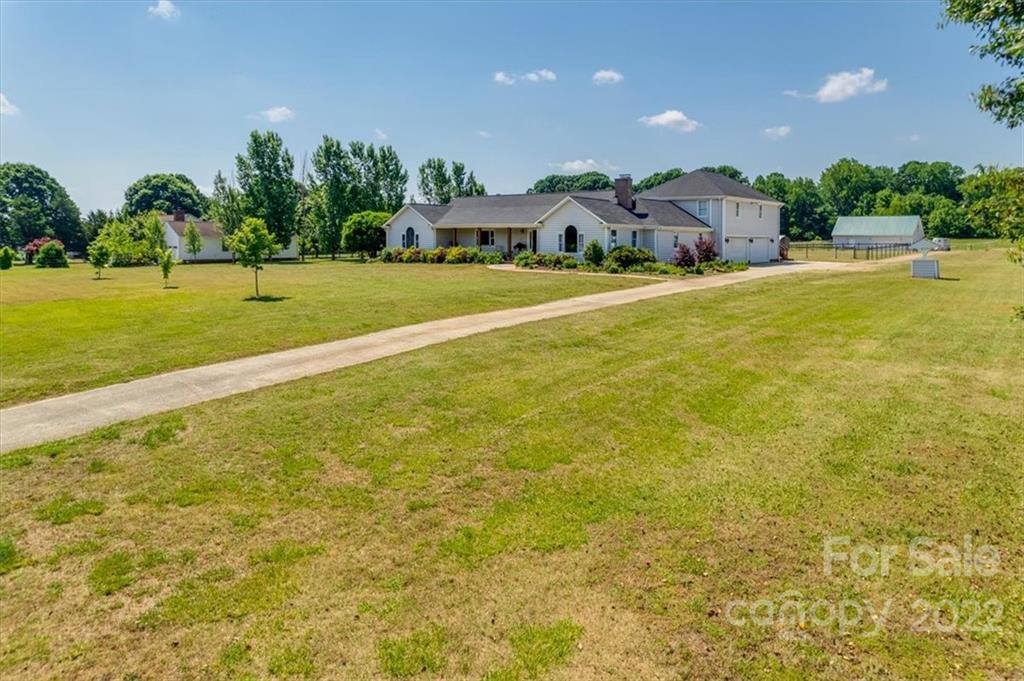 5249 Willow Pond Road Lake Wylie, SC 29710 - Photo 5 of 45 a house view with swimming pool and trees