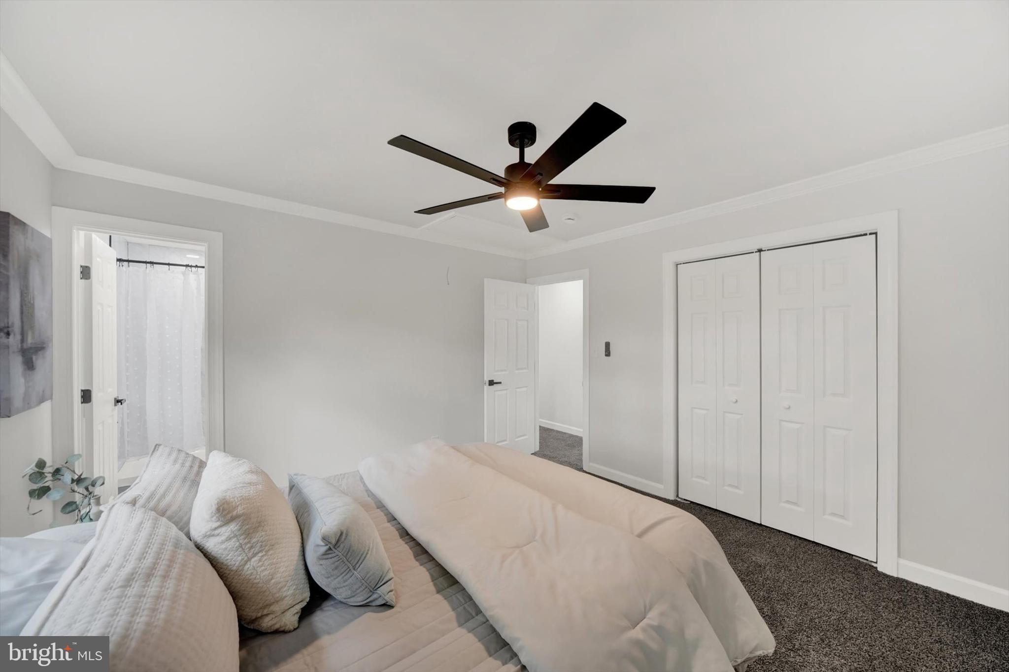 3808 Perryhurst Place Baltimore, MD 21236 - Photo 13 of 29 a bedroom with a large bed and a ceiling fan