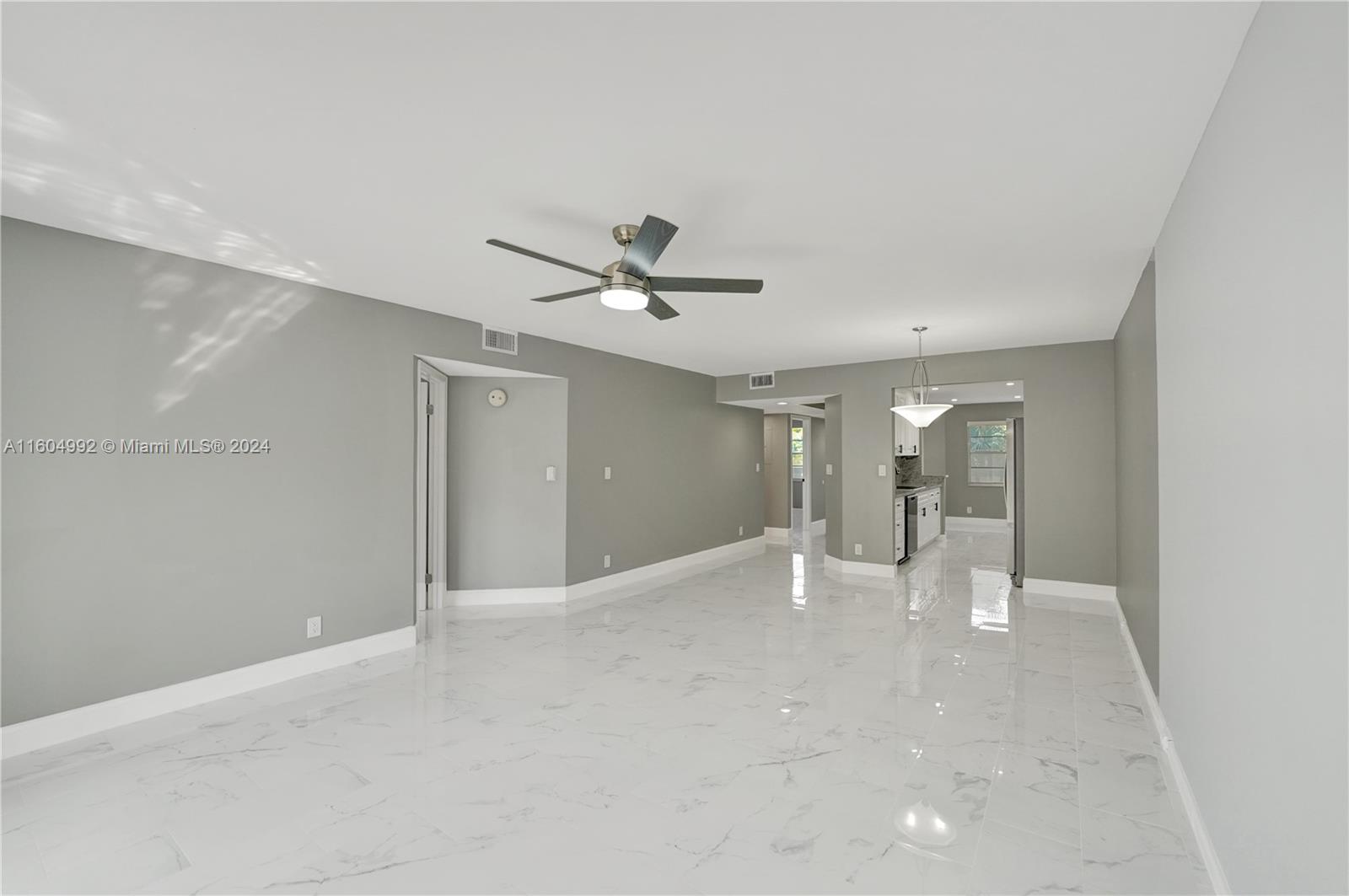 1802 Eleuthera Point, Unit E3 Coconut Creek, FL 33066 - Photo 16 of 78 a view of a livingroom with a ceiling fan and window